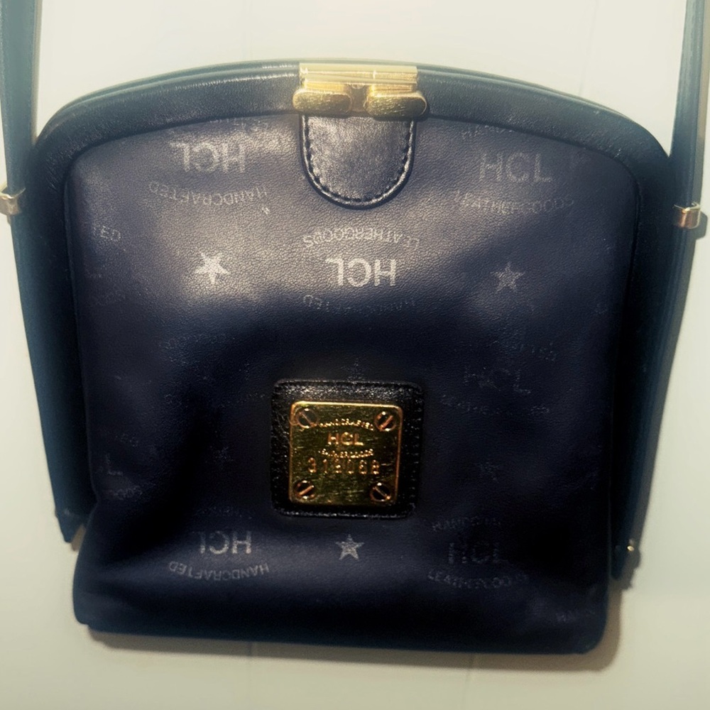 Black HCL Crossbody Bag with Gold Hardware and Dome Shape. made in Germany.
